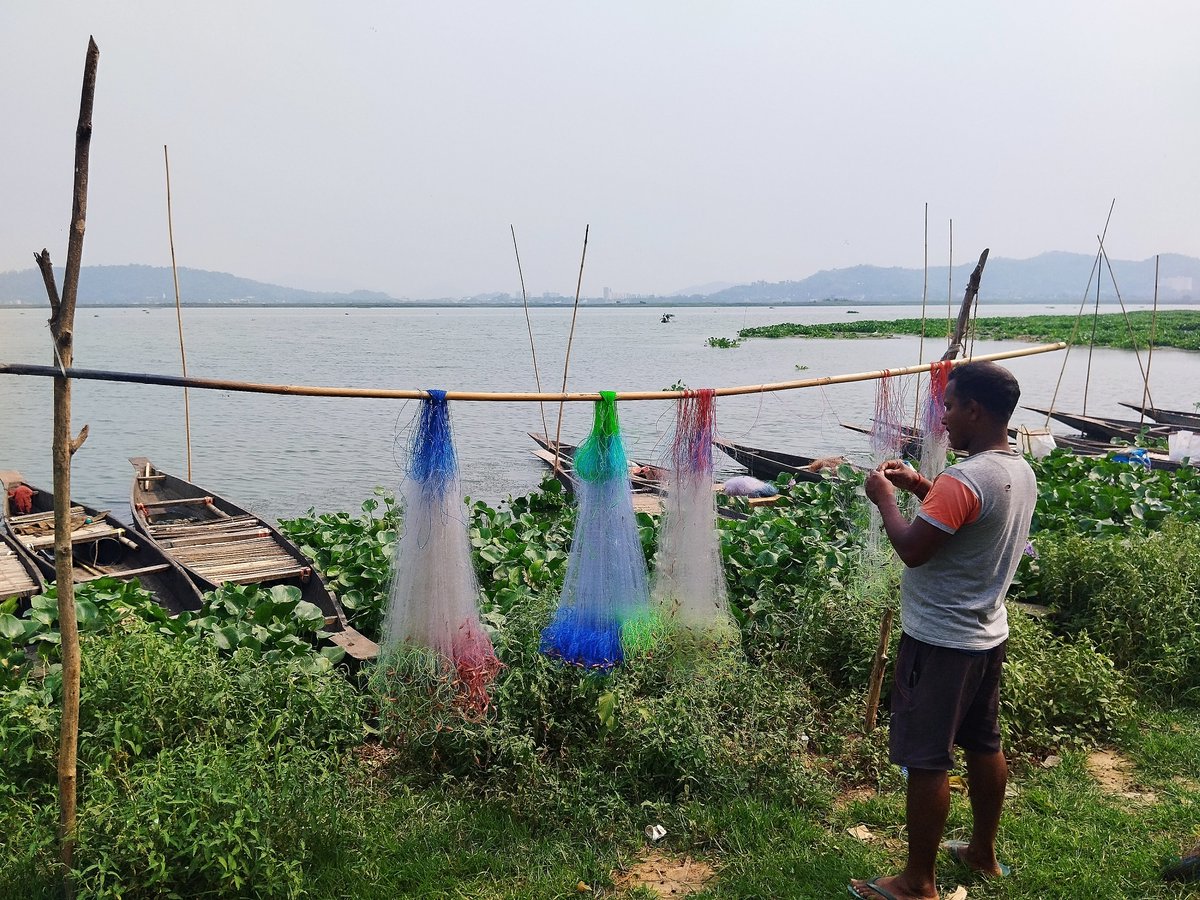 A fisherman repairing fishing nets- in Deepor Beel, a RAMSAR wetland in Assam @RamsarConv @ITMERG1