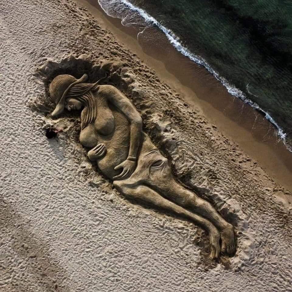 GiuliaTramontano e il suo bimbo Thiago, ricordati in una grande scultura di sabbia sulla spiaggia di Platamona in Sardegna, realizzata dall'artista Nicola Urru.