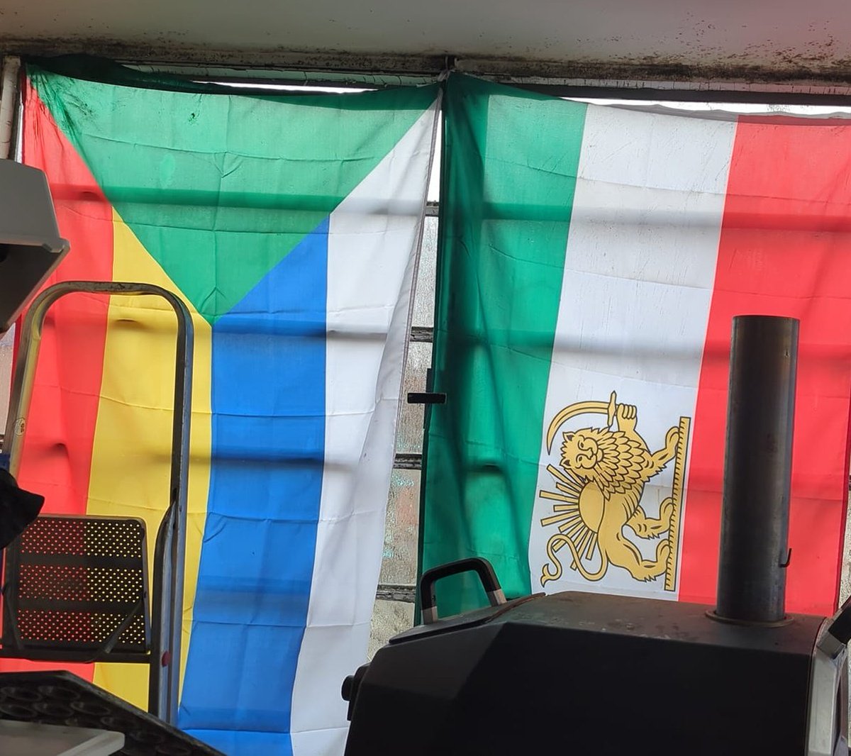 A Druze flag next to an Iranian flag.