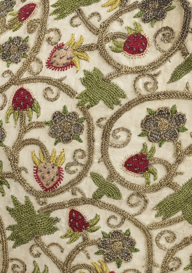 Left front and side of a woman's embroidered linen waistcoat, c. 1615, English Silk & metal threads in a pattern of strawberries. (Victoria & Albert Museum, London)