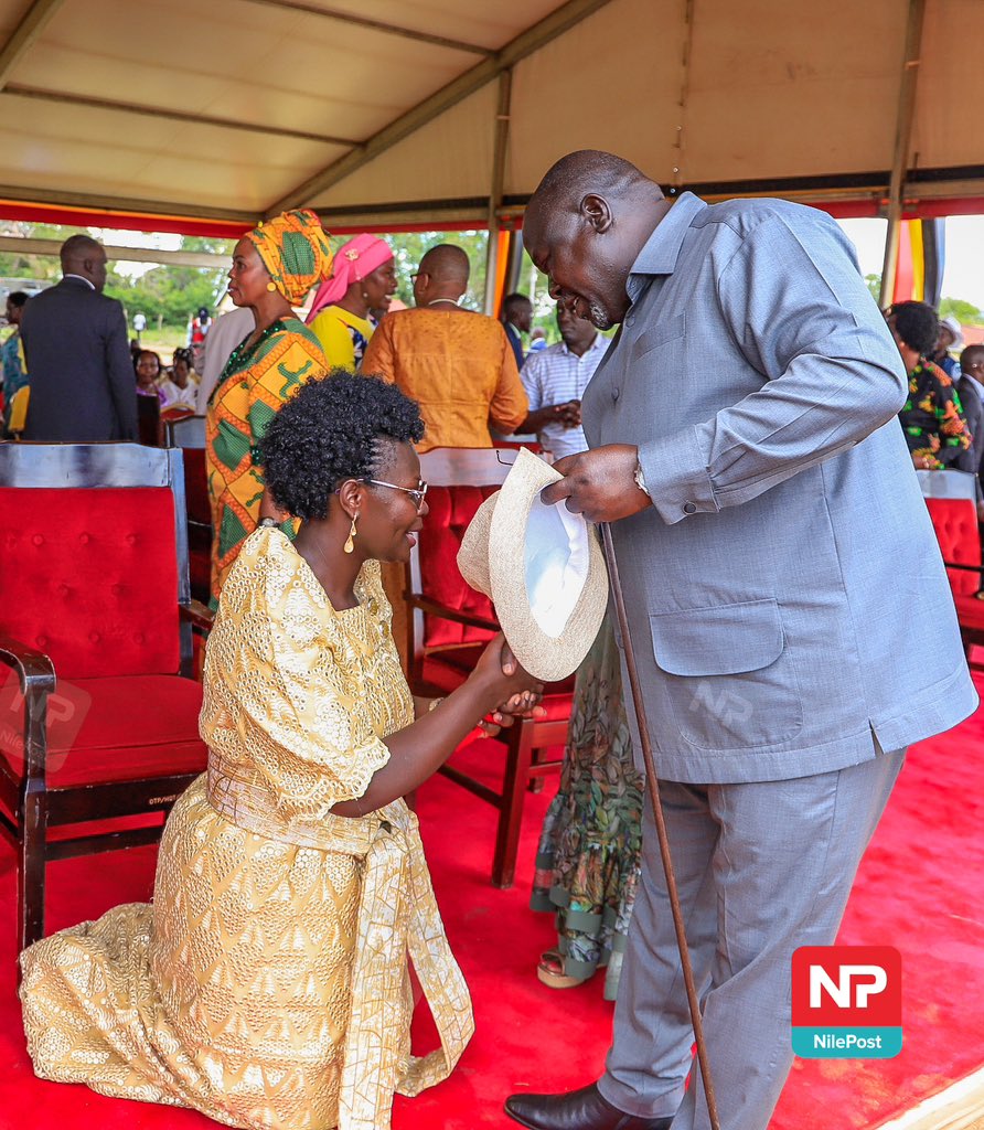 Honorable Minister @LillianAber kneels to greet Lt. Gen. Otema upon his arrival in Kitgum for the Thanksgiving ceremony