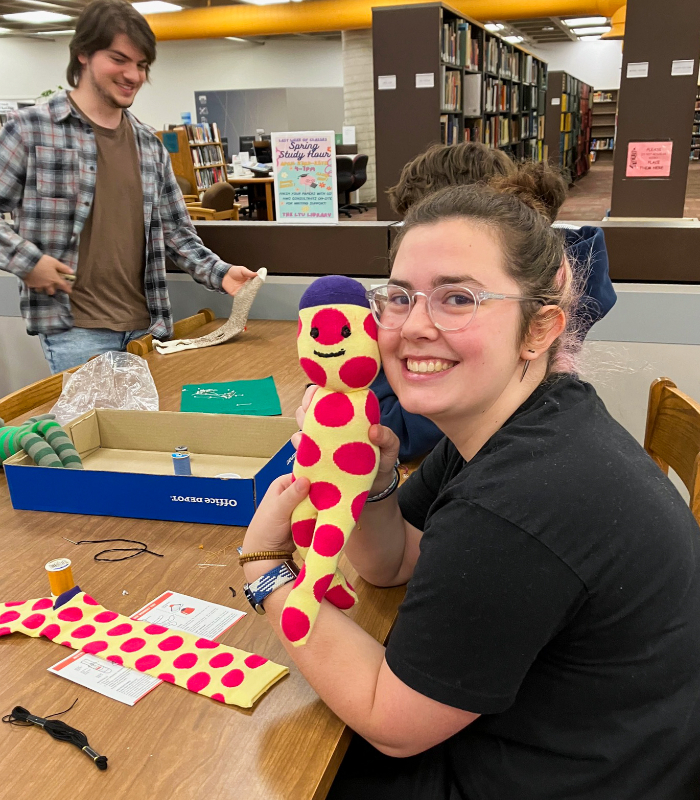 Destressing before finals by making sock monkeys at the Lawrence Technological University Library! 🐵 ✨ Be curious. Make magic. ✨ #WeAreLTU #StudentLife