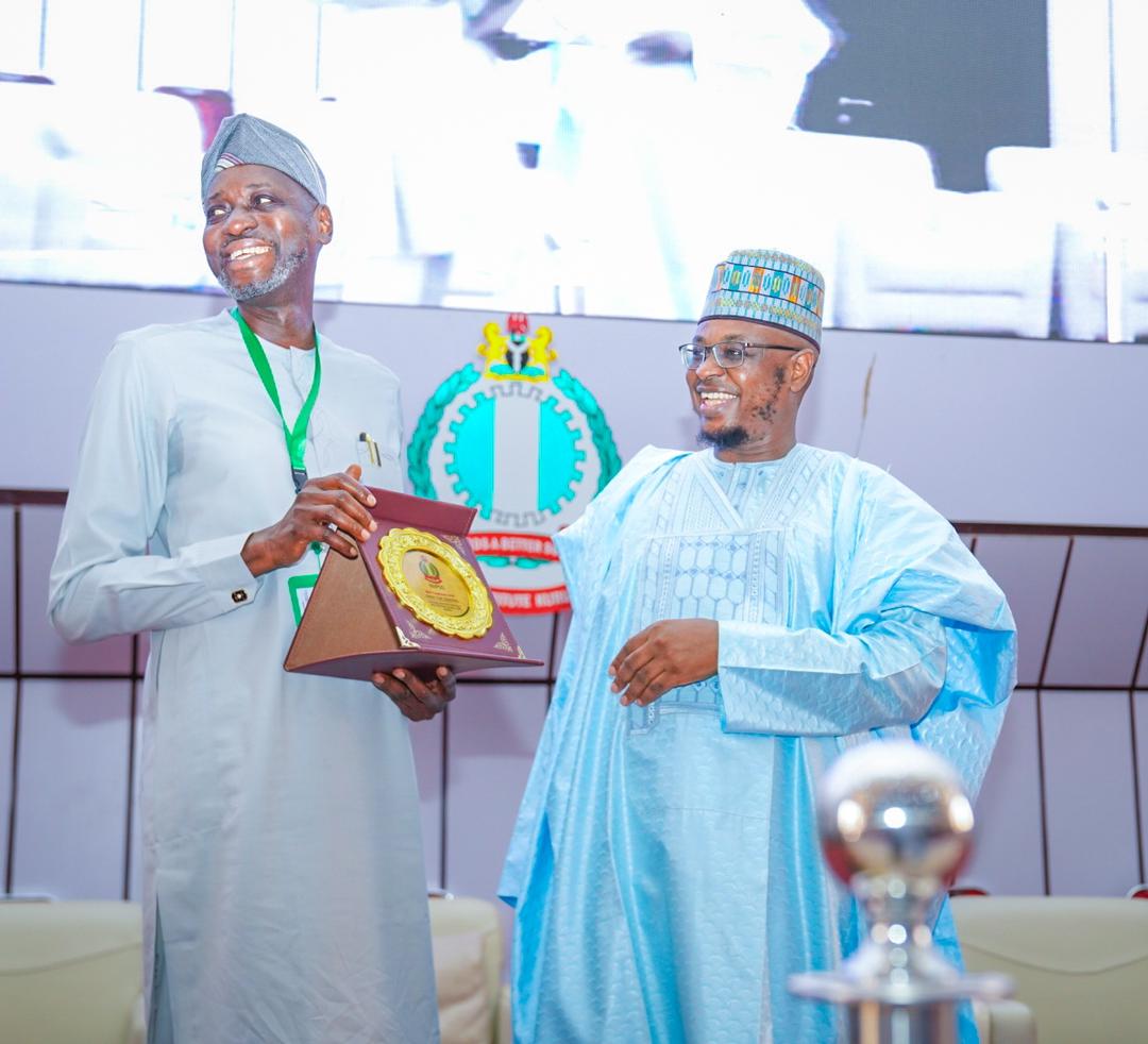 @ProfIsaPantami receives an award presented by the DG/CEO of the National Institute of Policy and Strategic Studies (NIPSS) Kuru, Professor Ayo Omitayo), yesterday.