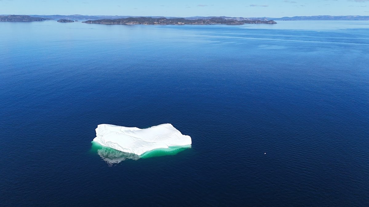 An #iceberg with Little Bay Islands #newfoundland in the background and us in a little wee boat!