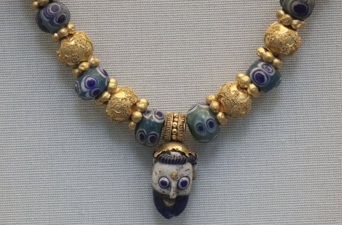 This striking Etruscan necklace, made over 2500 years ago, consists of eight gold beads decorated with filigree and granulation, sixteen gold spacer rings, five plain gold beads and fourteen glass eye beads. The pendant is a rod-formed Phoenician..(1/2) 📷March #Etruscan