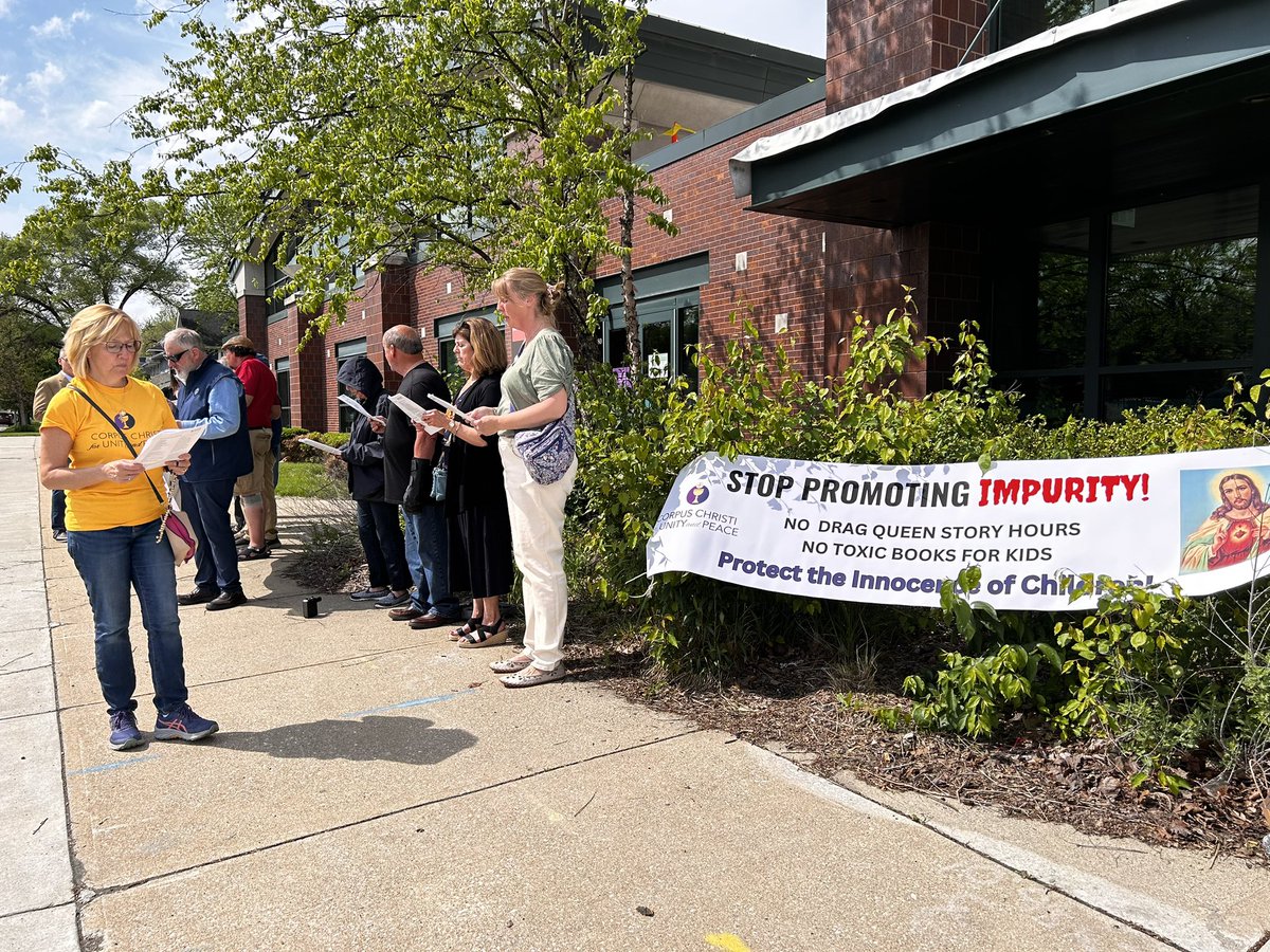 Passing by my neighborhood library at College Avenue and…a group outside protesting a drag storytime event that just finished. Couple IMPD cars in lot. They were all reading from packet of prayers out loud so didn’t talk to them.