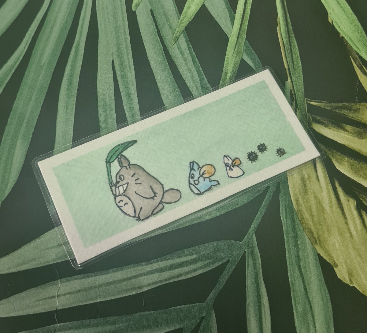 A hand-painted bookmark showing a Totoro and friends on a green background with silver highlights.

Available at: claredoodles.etsy.com

#etsy #handpainted #bookmark #ghibli #Totoro #myneighbortotoro #SmallBusiness #disabledownedbusiness