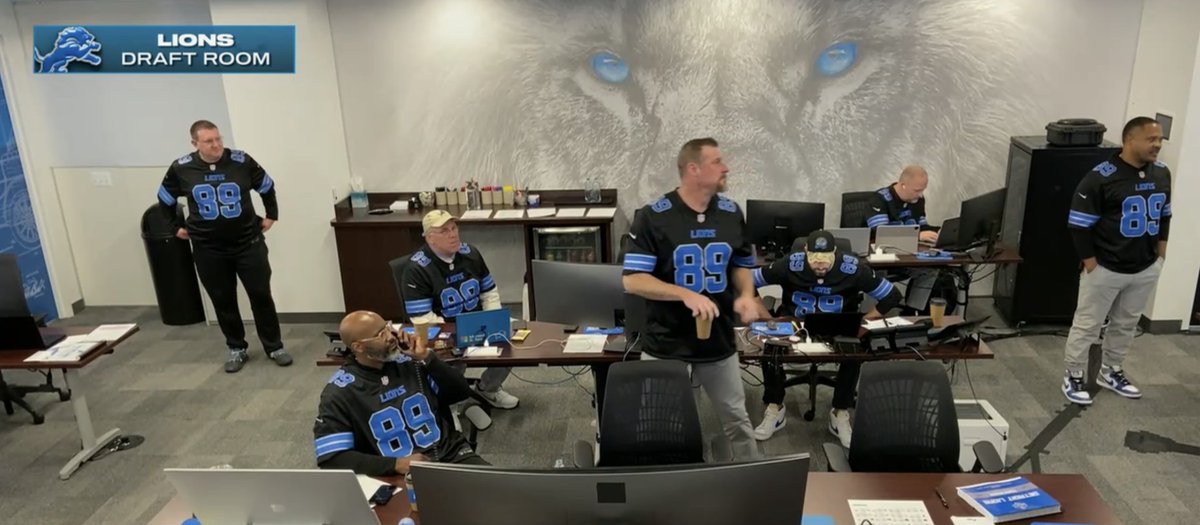 Everyone in the Lions' NFL Draft room is wearing a Dan Campbell 89 jersey.