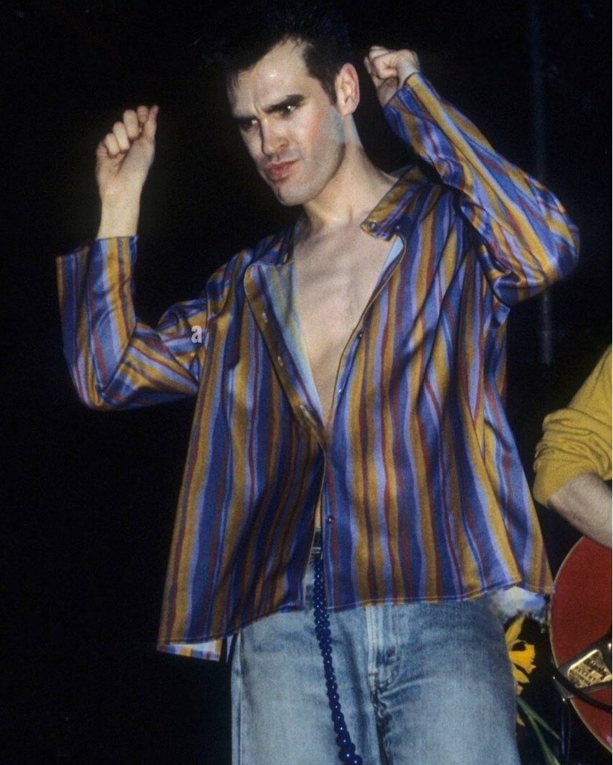 What is going on with Morrissey’s face here?? Photo circa 1984, when The Smiths played Hammersmith Palais.