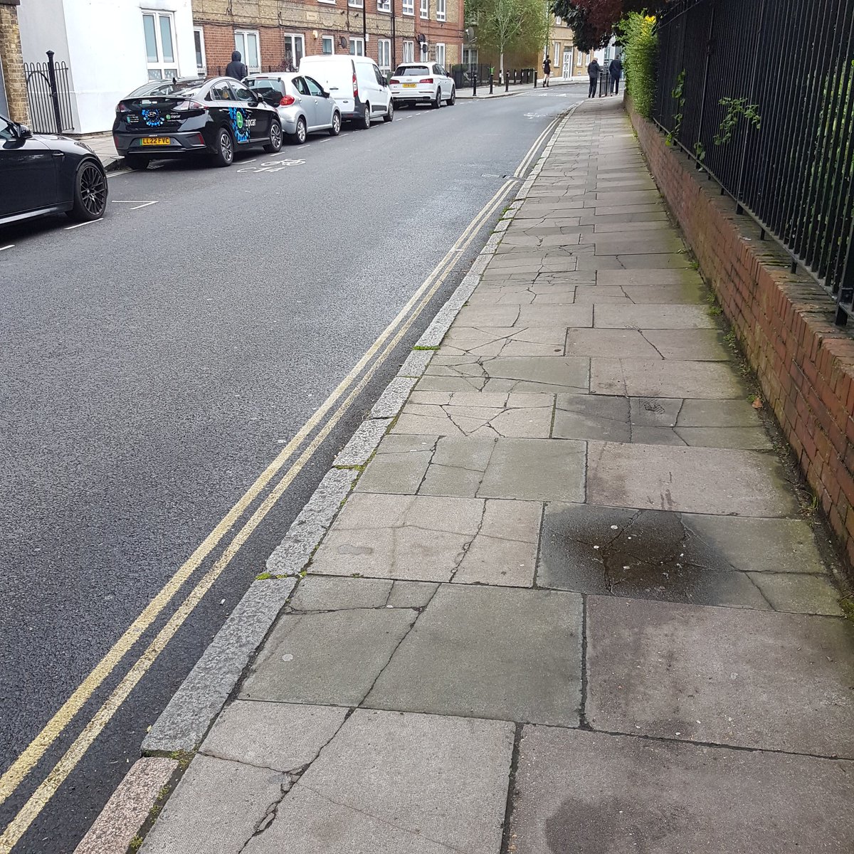 Two views of the same street. In one the pavement is in good condition, turn 180° and it's all cracked and broken. What could be the reason?