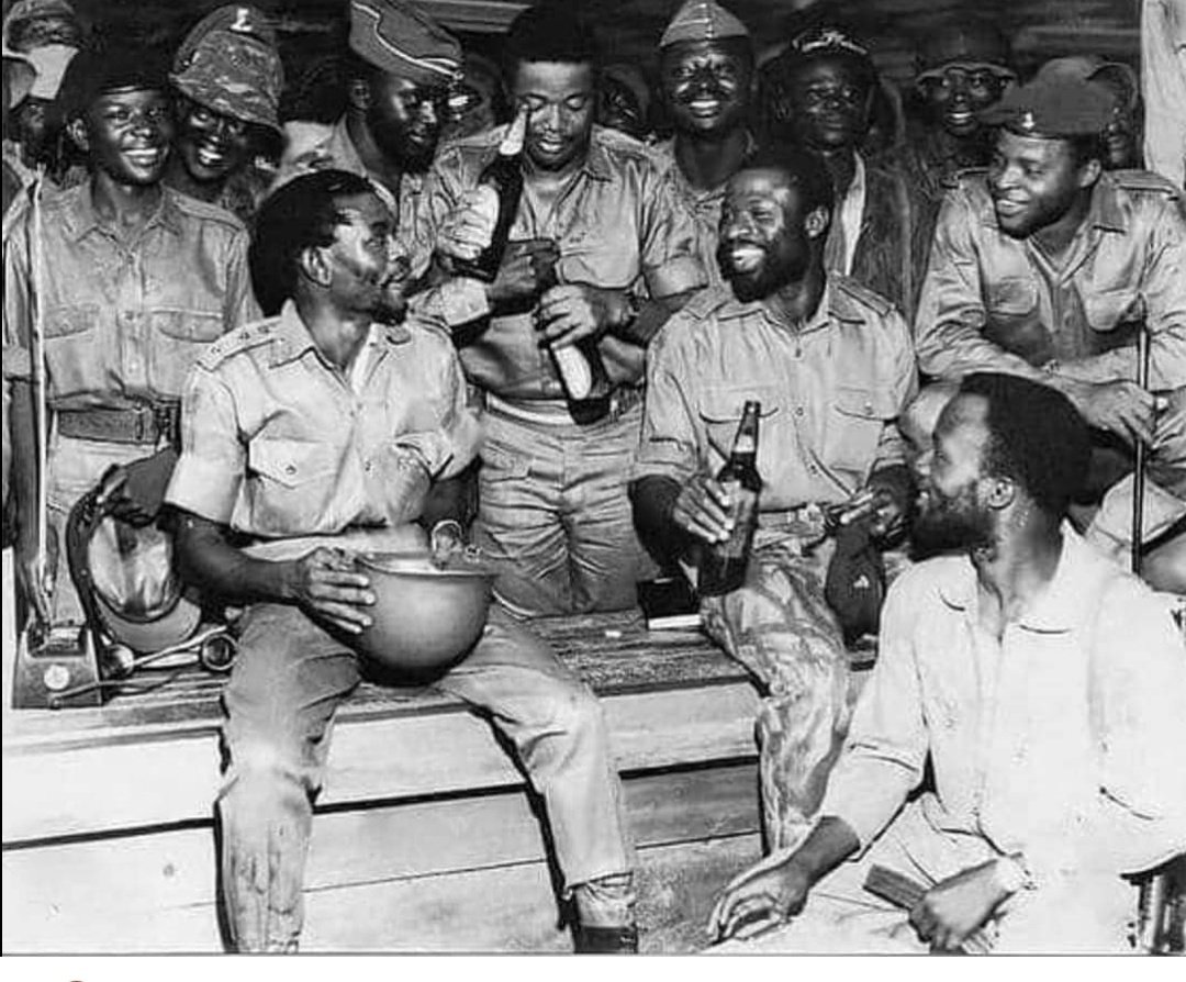 Col Benjamin Adekunle 'Black Scorpion 'The conqueror of the Biafra army Drinking from helmet, Shares drink of victory with his men following the recapture of Port Harcourt To his left Chief of staff Lt.col Alabi,Alani Akinrinade squatting far right Other notable Yoruba war…