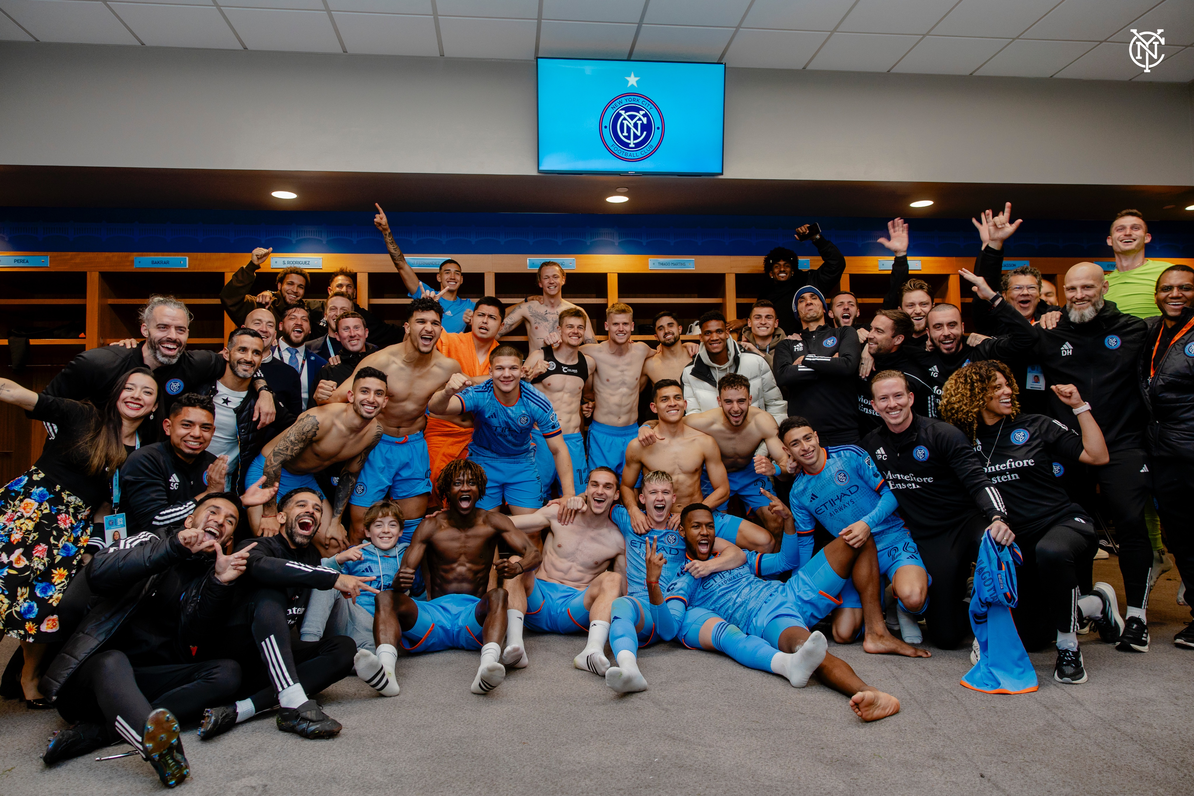 Full team photo post-match in the locker room.