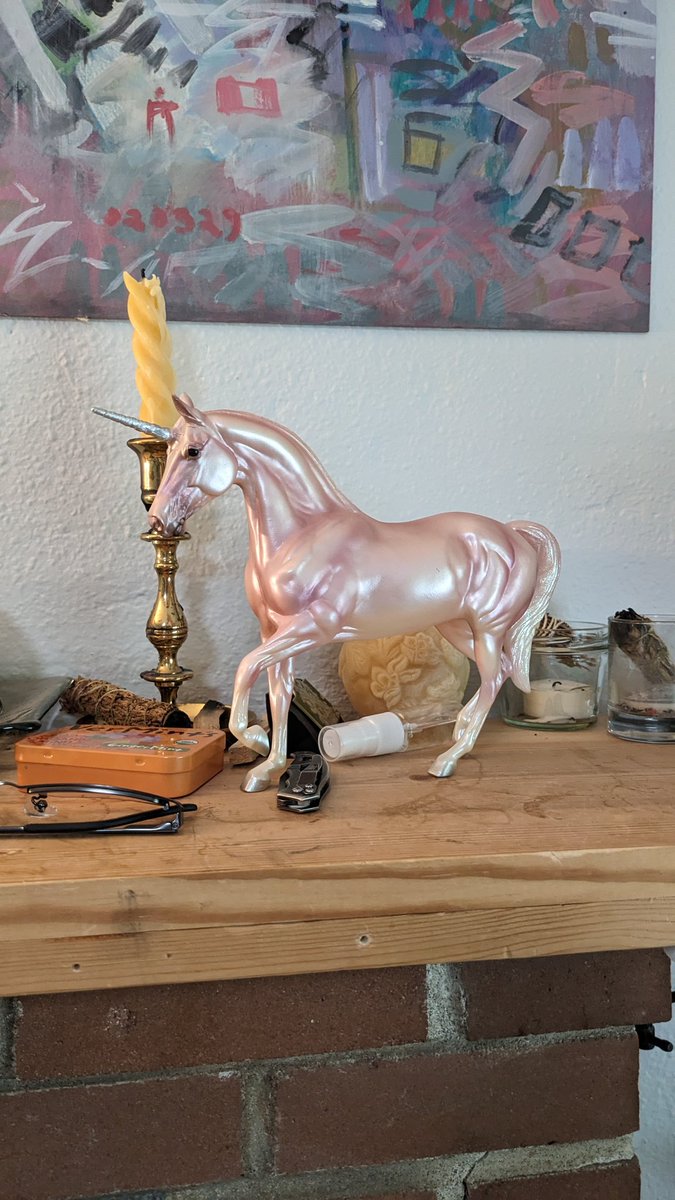Everyone look at this BAD ASS breyer unicorn from like the mid 2000s I bought at magic mouse . For the family mantle of course. Really makes you say HELL YEAH. she is so beautiful