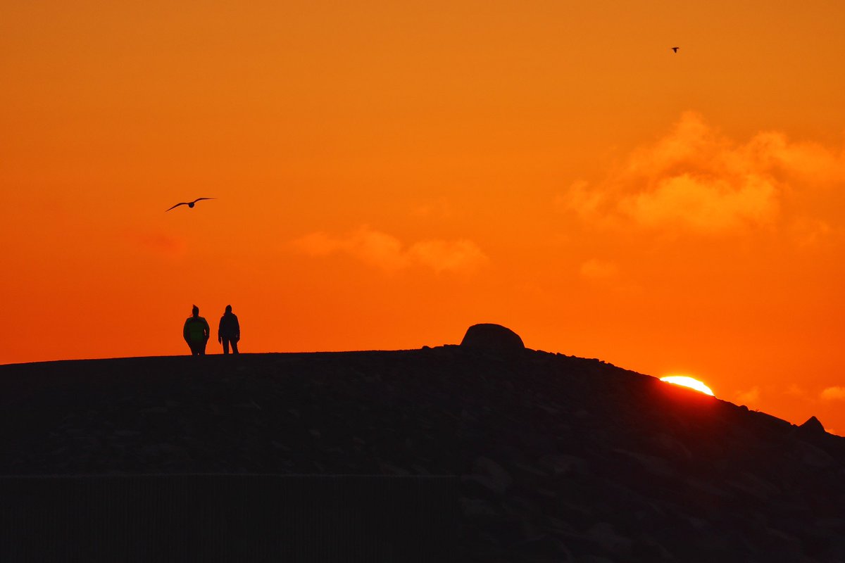 A couple people enjoying tonight’s sunset from Moses Point. Bonavista, NL