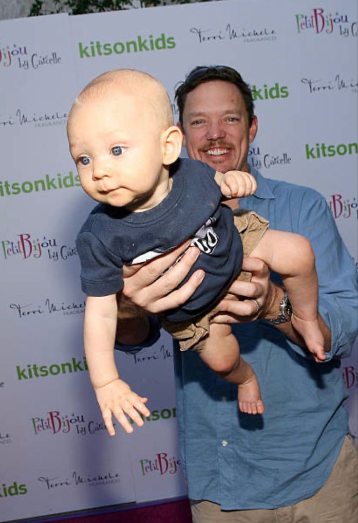 Skidad holding baby skid like this