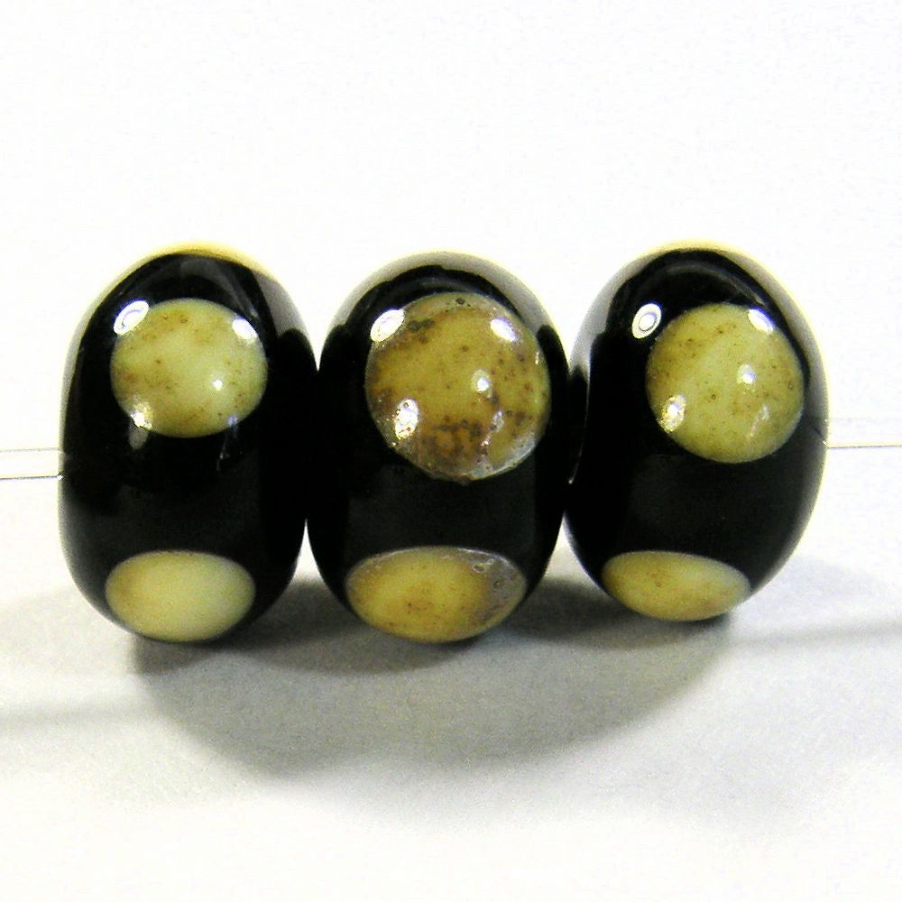 Black handmade lampwork glass beads with rustic nugget silvered ivory dots and a shiny glass bead finish.  The silvered ivory dots were left slightly raised creating a nugget style beads bit.ly/BlackRusticSID… via @Covergirlbeads #ejwtt #LampworkBeads #ShopSmall