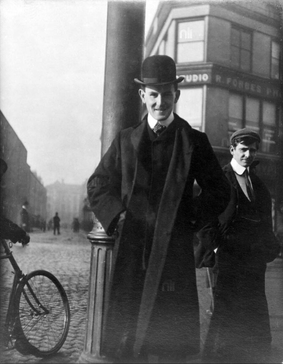 Man standing by lamp post at the junction of Grafton Street and South King Street, Dublin.  (You can see the lamppost too in the previously posted picture) R. Forbes Photographic Studio visible in background.  Photo: John. J. Clarke, J. J.  c. 1900