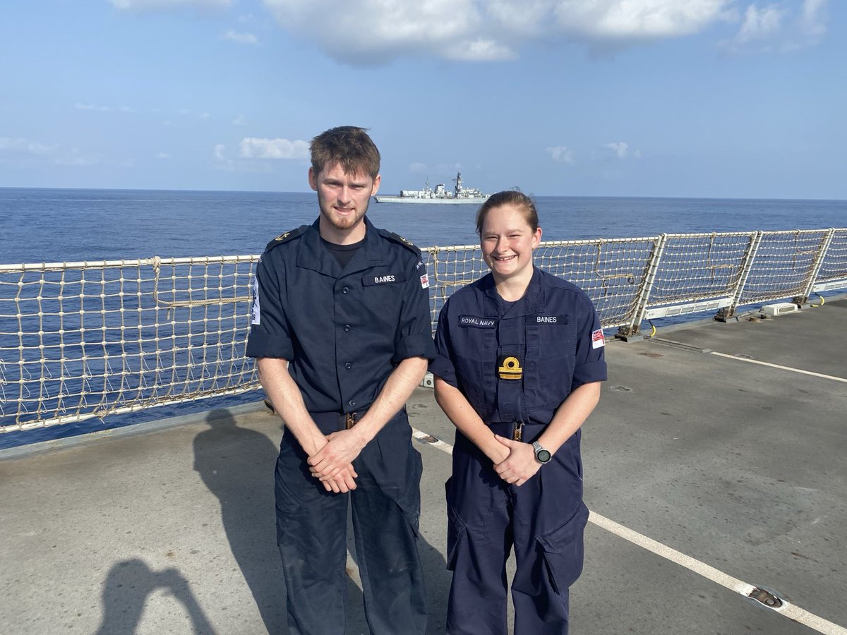 A family reunion for Lt Katy Baines RN and her brother LET(WE) Joseph Baines on the Flight Deck of HMS DIAMOND (HMS LANCASTER in the background) during a short rendezvous whilst both units are deployed on operations east of the Suez Canal.