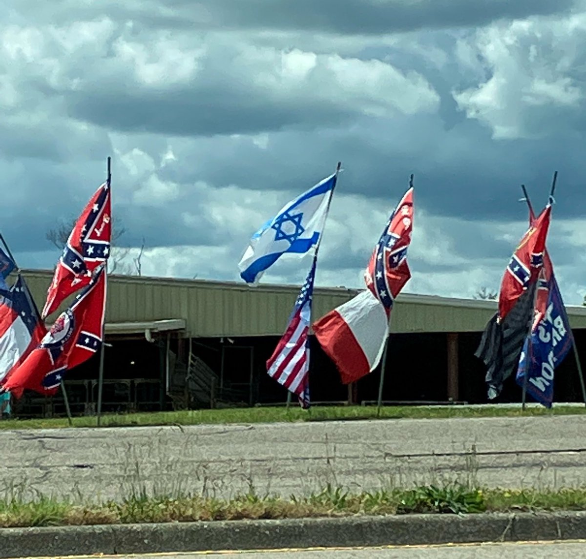 Israeli and Confederate flags for sale by the side of the road. Tennessee, USA. (Forgive the bad photography; image taken from a moving car.)