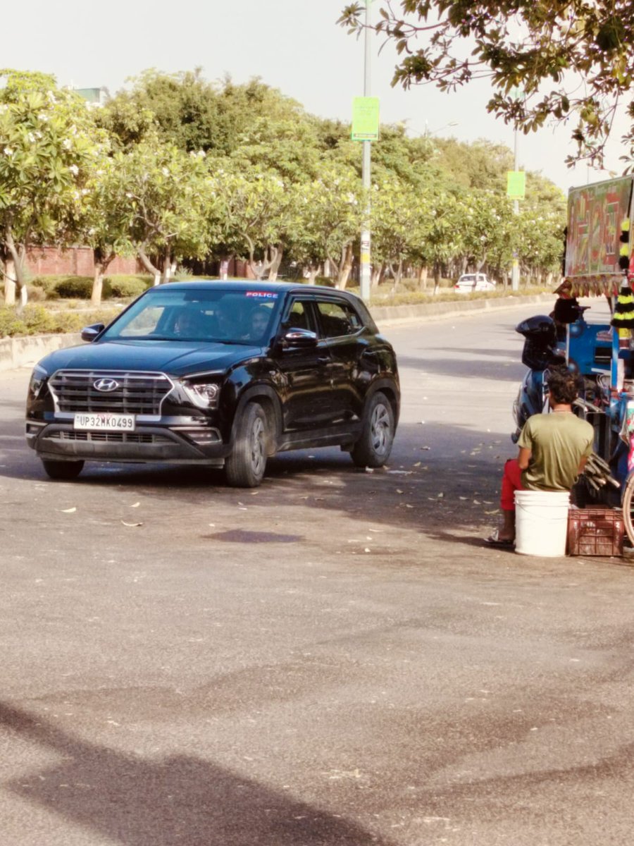 PathakAsheesh's tweet photo. @lucknowtraffic @Uppolice @lkopolice This black car was parked in mid of road at Sushant Golf City , nr Lotus school. When objected , occupants told me that road is wide enough , drive away . Irony is car bears police Sticker . You can zoom in to check number plate . https://t.co/C3AA0kF6Tw