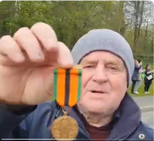 An evocative image of a proud son marching today in #Newtownmountkennedy with his father's IRA medal from the War of Indepdendence in 1921. The Irish people have got this, we've been here before, we will never be defeated. #Ireland