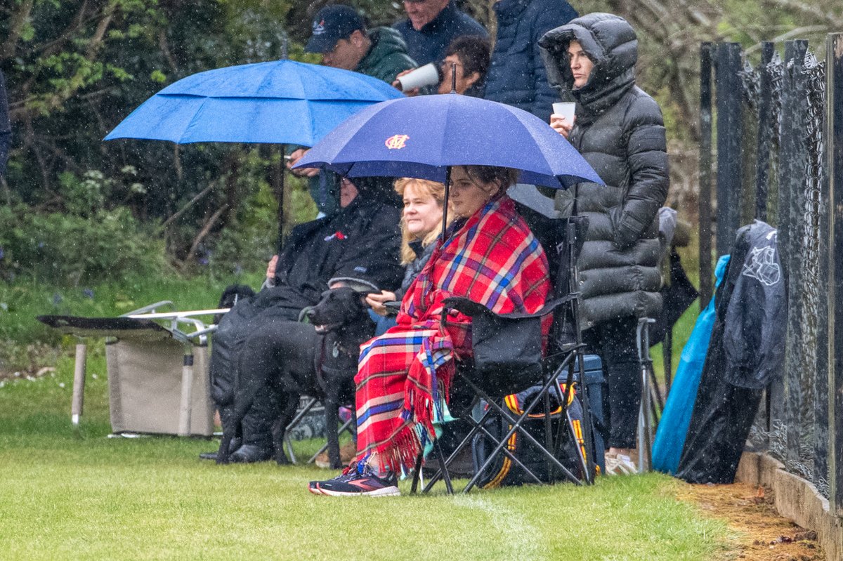 The joys of watching cricket in April ... these are hardy spectators yesterday afternoon as play continued in persistent drizzle ...