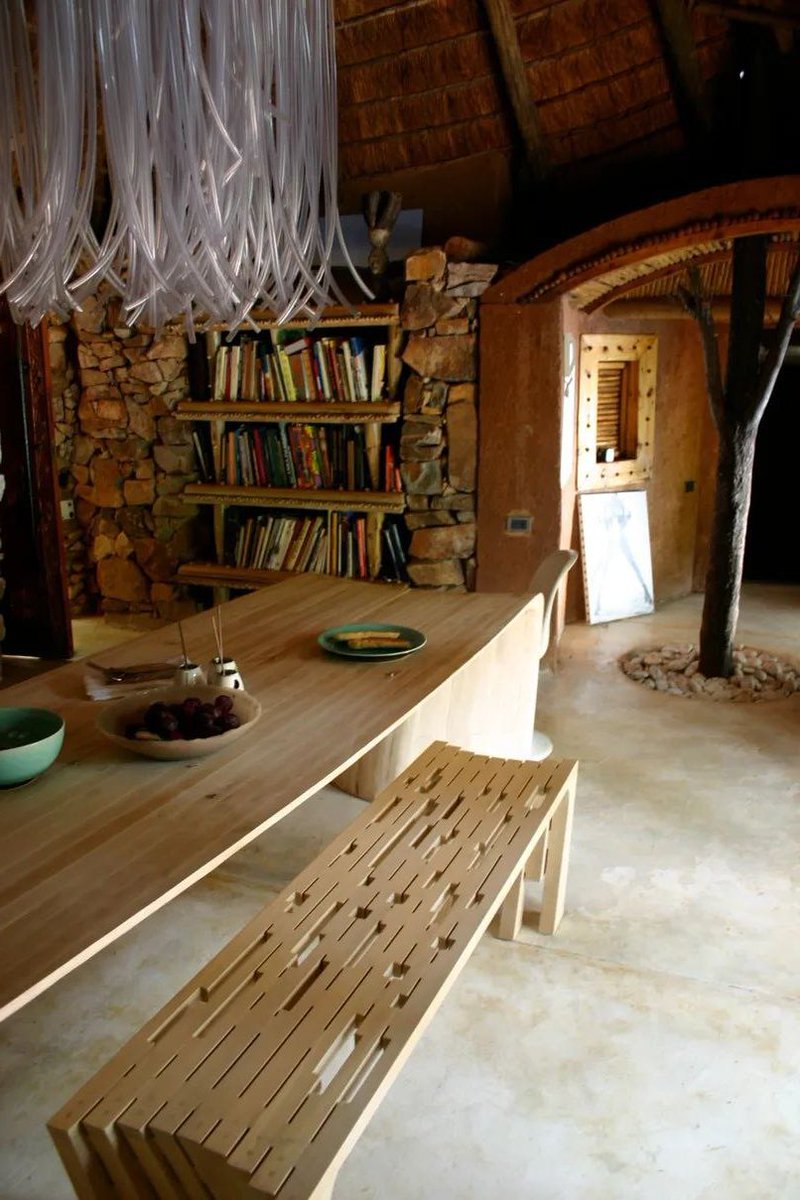 The stone walls of the dining room support the worktops and shelves for miscellaneous items.