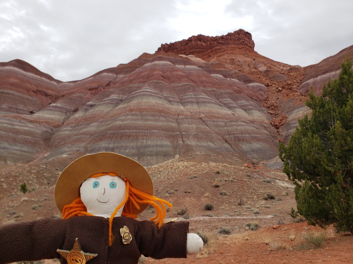 Someone spilled a rainbow. Ranger Sarah is amazed by these colorful mountains. The side of the mountains have spectacular colors due to encrusted minerals like iron oxides, manganese, cobalt and others. — at Grand Staircase-Escalante National Monument. #adventuresofrangersarah