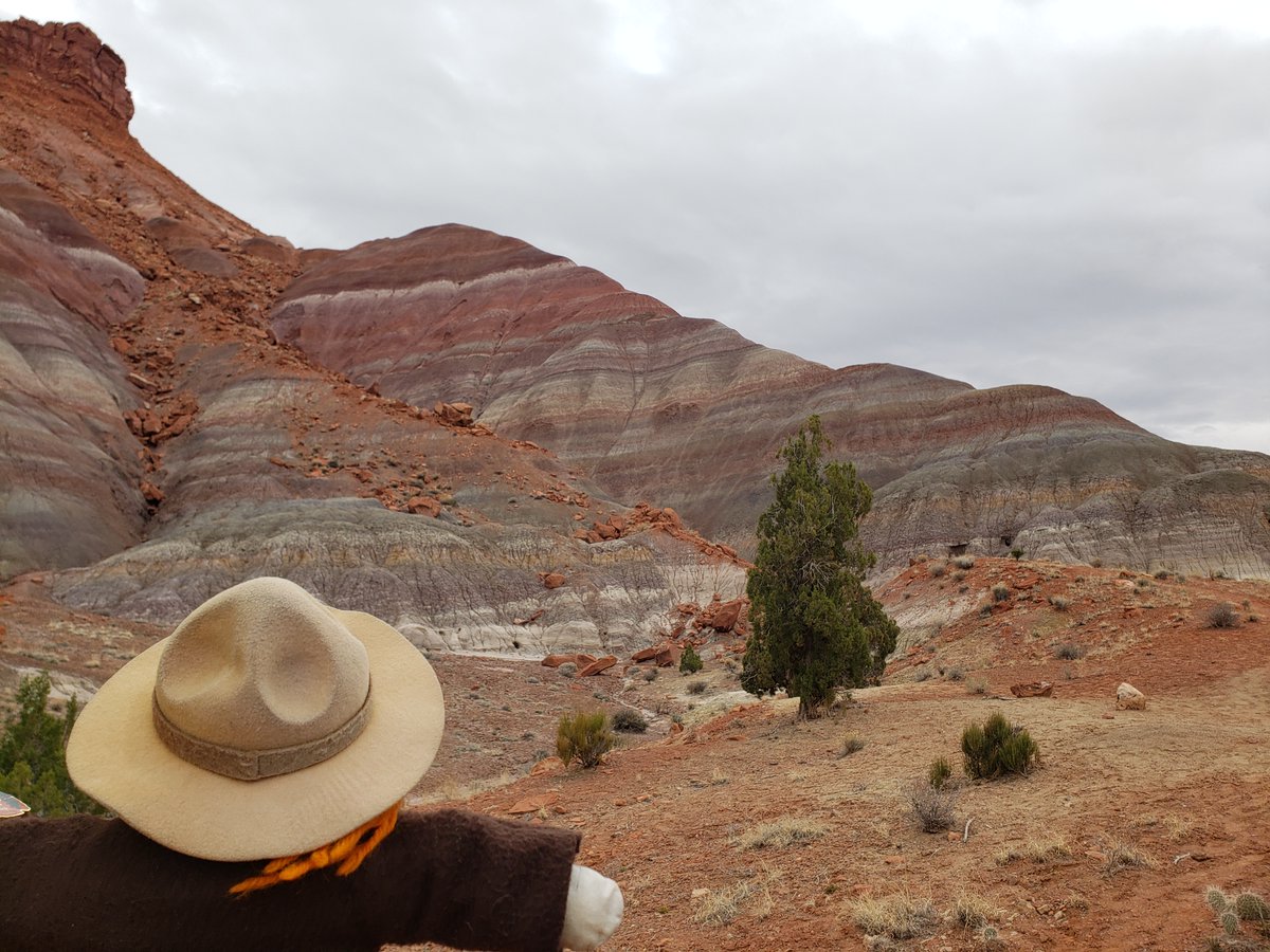 Ranger Sarah views the Paria Mountains. The red and orange colors are caused by the presence of iron oxides. — Grand Staircase-Escalante National Monument. #adventuresofrangersarah #rangersarah #grandstaircaseescalante #hiking #geology #geologyrocks #outdooradventures #outdoors