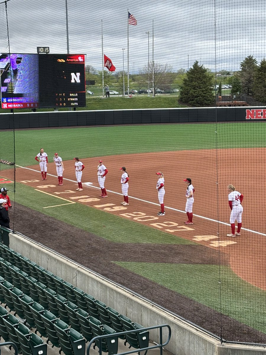 The @huskersoftball seniors taking pics next to their uni numbers on the field at Bowlin. #Huskers