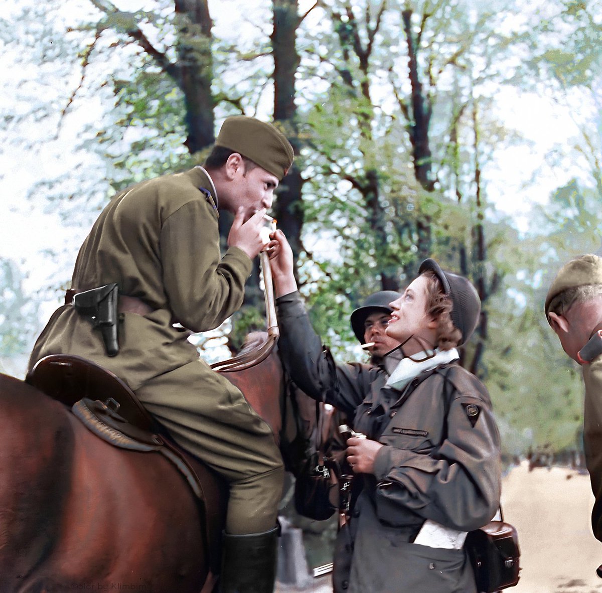 War Correspondent Lee Miller lights the cigarette of a Red Army Cavalryman after the link-up between US and Soviet forces near Torgau Germany - April 1945