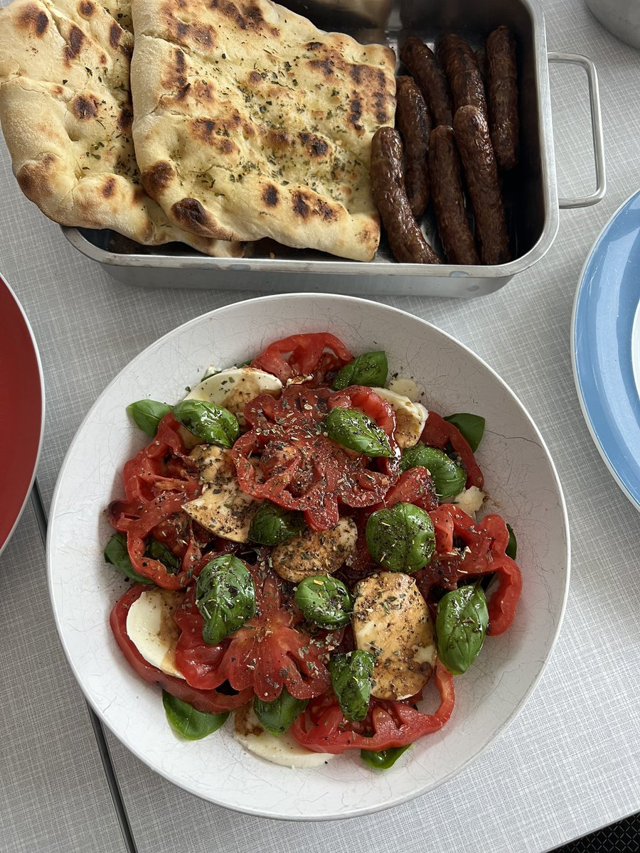 Lamb bratwurst & flatbread from the grill with some arugula, cherry tomato & cucumber salad, feta & peppers spread & some caprese for dinner