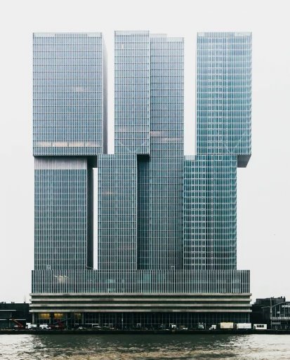 De Rotterdam on the Wilhelminapier was completed in 2013 and designed by Rem Koolhaas, Ellen van Loon, Reinier de Graaf, and Kees van Casteren. The three stacked and interconnecting towers rise 44 floors to a height of 150 metres and span a width of over 100 metres #architecture