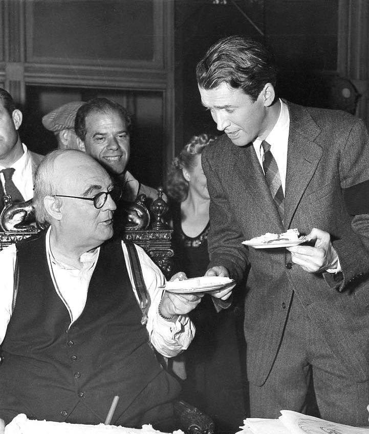 Lionel Barrymore talking with James Stewart as Frank Capra looks on on the set of 'It's a Wonderful Life.' Born on this date in 1878, Barrymore was one of the great actors of his generation. He won the #BestActor Oscar for “A Free Soul.”

#LionelBarrymore #JimmyStewart