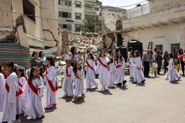 Gazan children celebrating Orthodox Palm Sunday amidst rubble, genocide, and famine.