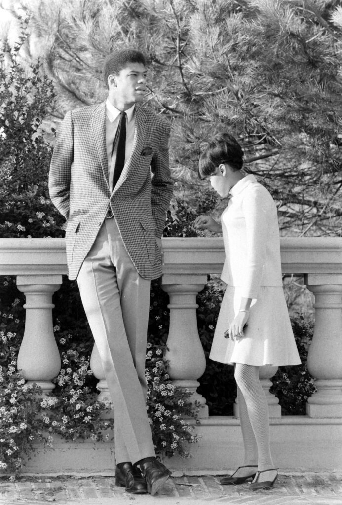 Kareem Abdul-Jabbar in 1967, when he was a sophomore at UCLA. Kareem was an early customer of custom tailors. His tailor, who had to stand on a chair to measure his chest, noted that he had an inseam of 51'. Note the high-rise trousers and longer jacket.