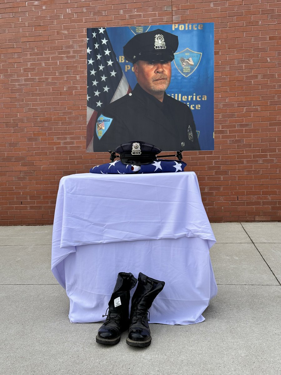 At the end of the vigil, two of Sgt. Ian Taylor’s fellow Billerica officers carry his boots, hat and an American flag. @BillericaPD and @TownofBillerica