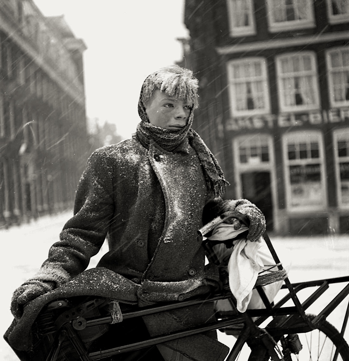 Boy with his bike in the snow during a cold winter, Amsterdam, 1938 - by Emmy Andriesse (1914 -1953), Dutch