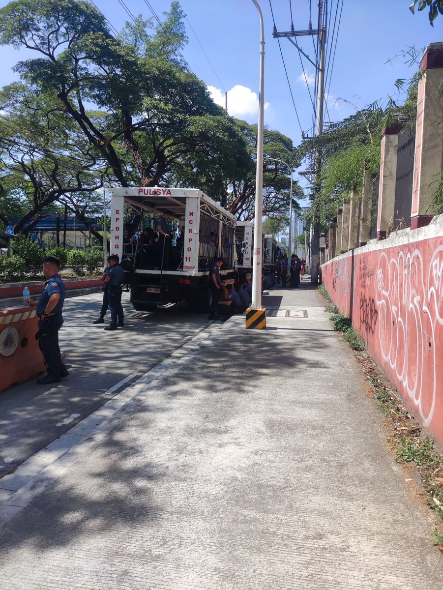 LOOK: Elements of the Philippine National Police have infiltrated university grounds via Quirino Gate. At least five trucks, all carrying police officers at full capacity, are parked in front of the gate. This, alongside concurrent sightings of Quezon City Police District trucks
