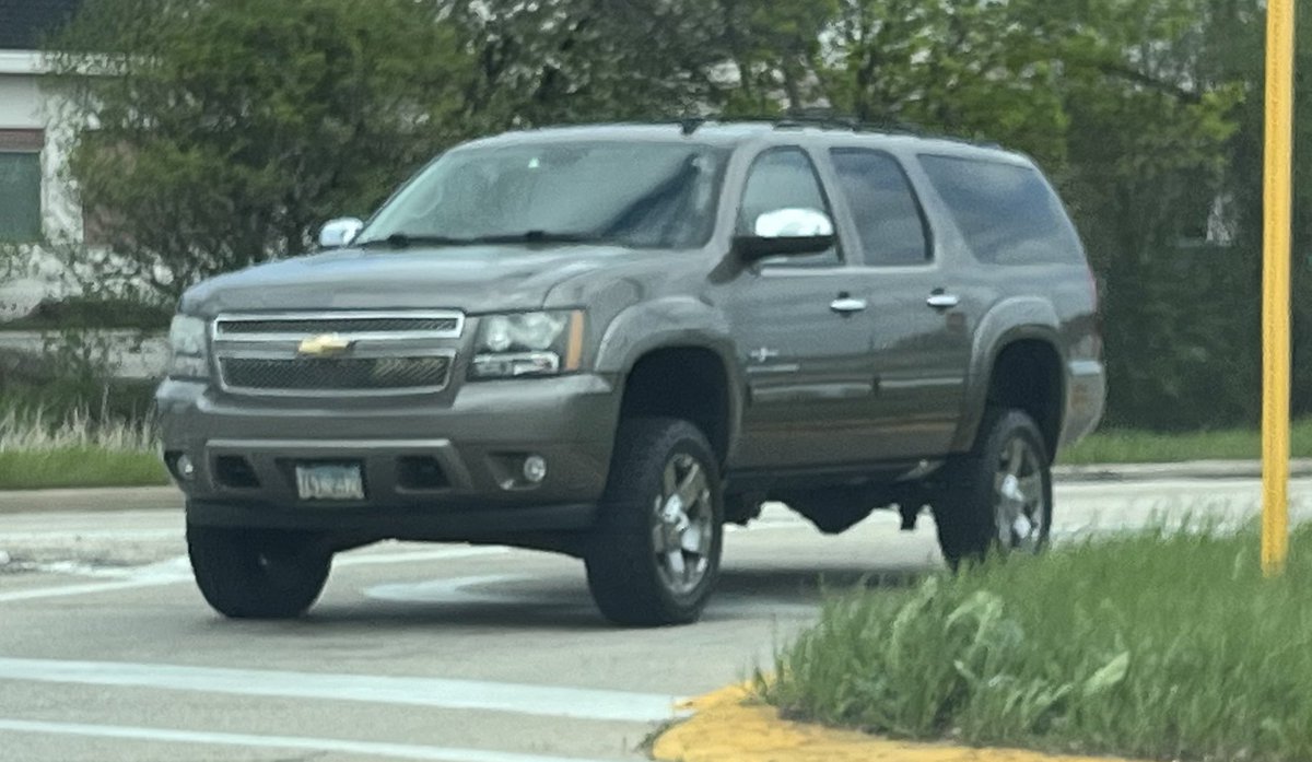 Lifted Suburban for no apparent reason.  Not a good look.  Maybe throw some fat tires in those gaping wheel wells?  

#carspotter