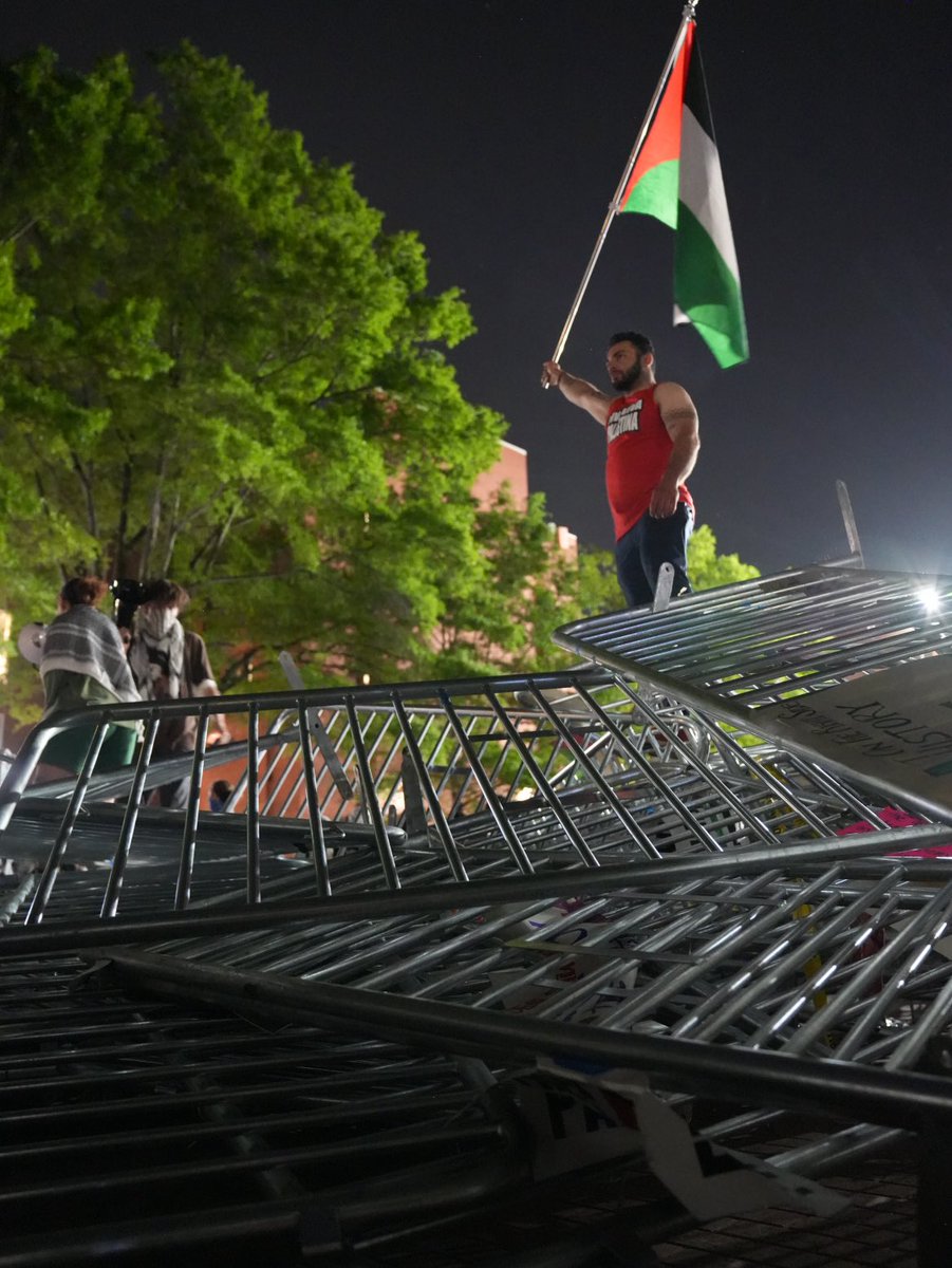 GWU students have torn down the barricades surrounding their encampment and piled them in the middle of the U Yard quad on campus.