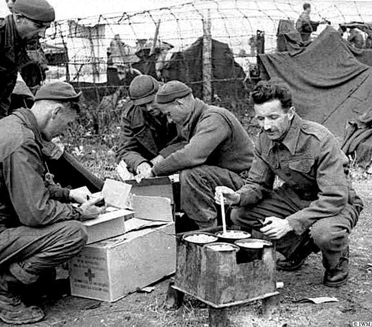 #OTD in 1945, Stalag 7A. Germany. A former British POW cooking food on a homemade stove and Americans examining food parcels. #WW2 #HISTORY