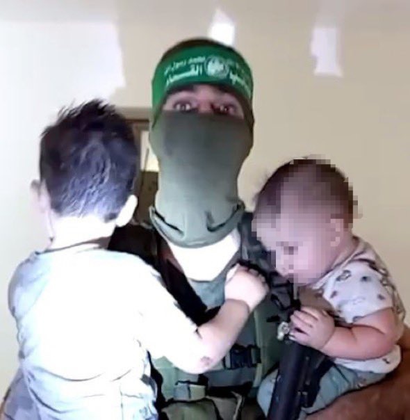 On October 7th, terrorists murdered the mother of these two small children. 
They hid her body under the bed and booby trapped her so that when rescue forces reached her they would explode. 
After that they took pictures of themselves with the two small children as if they were