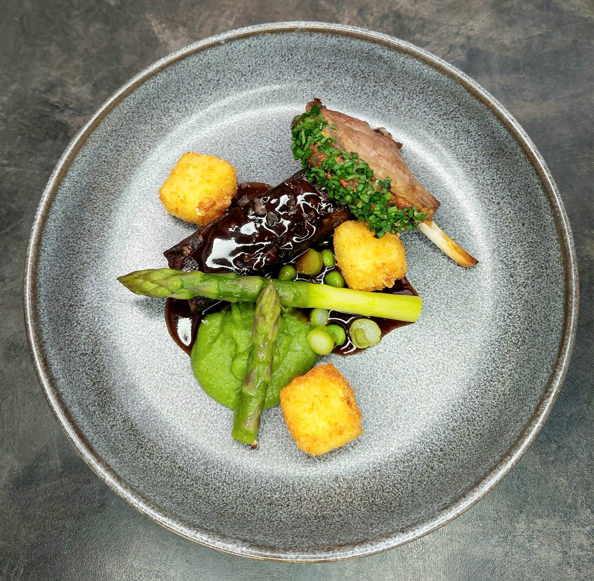 Stephen_Whalen's tweet photo. @sat_jamesmartin following your masterclass on lamb, I was inspired to make this. Lamb neck, braised for 10 hours, pressed overnight then sliced and pan fried until crispy. Served with a grilled lamb cutlet, feta croquettes, pea puree, asparagus, and a minted lamb sauce 😋 https://t.co/TFHWIxnN1v