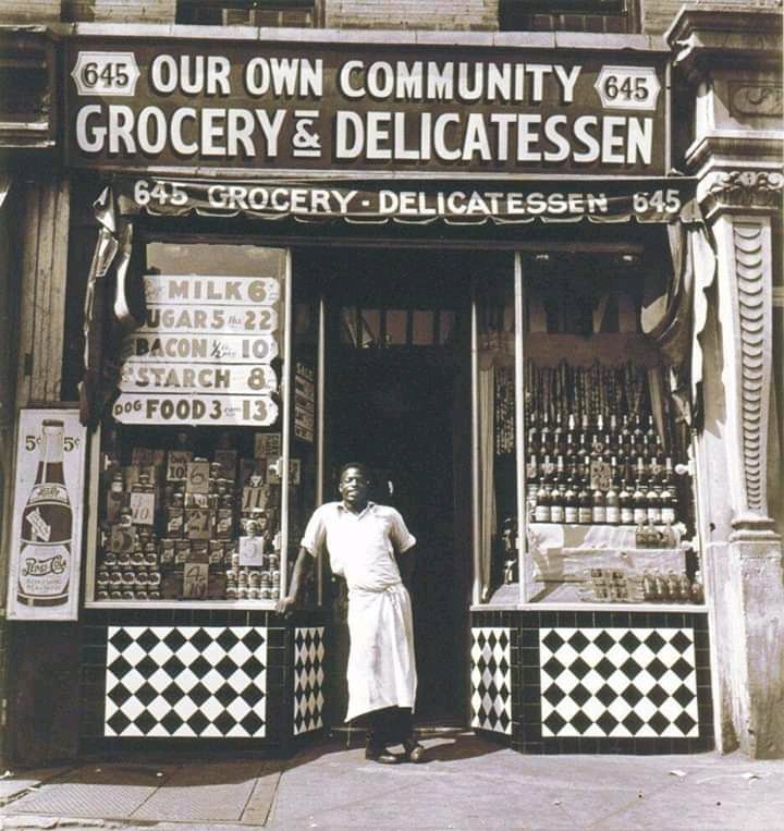 A Harlem grocer standing in front of his store, 1937. 'Be Black, Buy Black, Think Black, and all else will take care of itself!' Marcus Mosiah Garvey ❤️🖤 💚