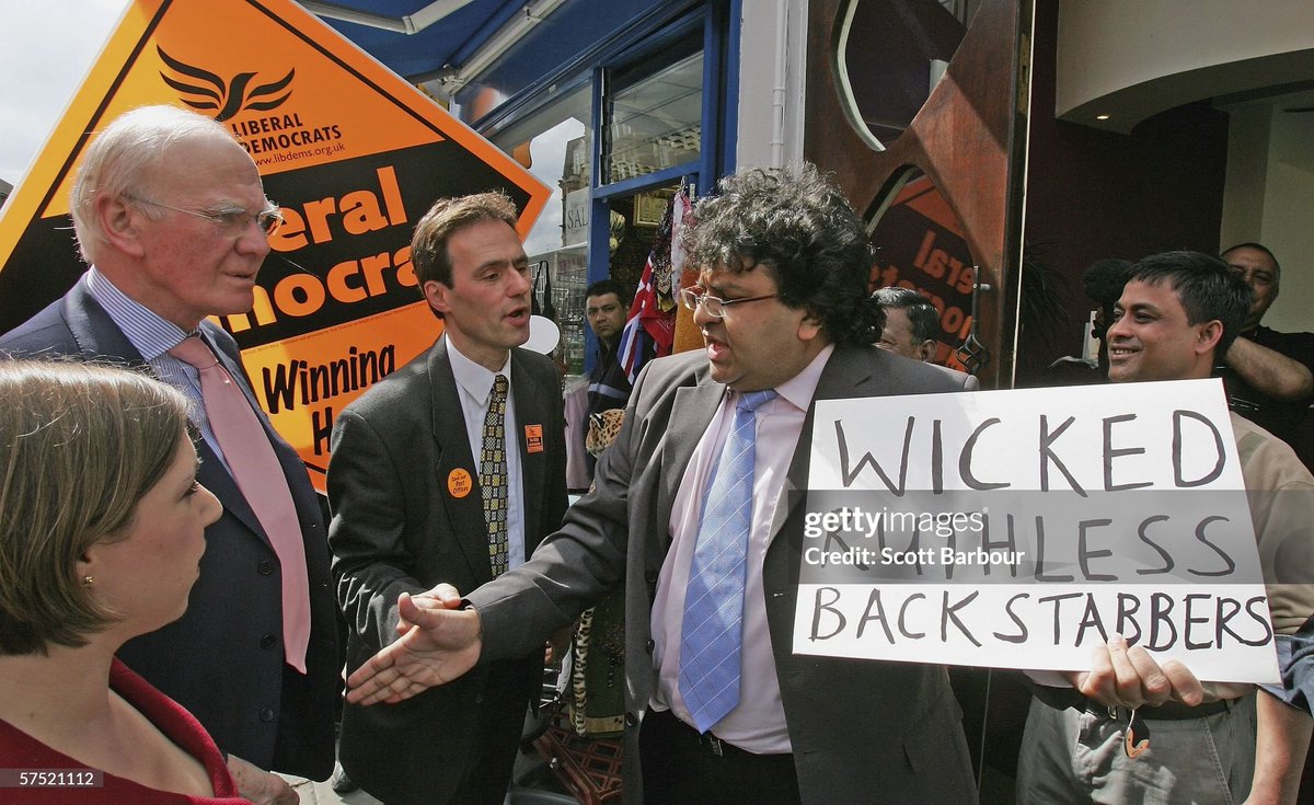 Liberal Democrat leader Sir Menzies Campbell (2nd L) along with local candidate Sarah Teather encounter a protestor during a walk down Willesden High Road to help maximize the vote for the upcoming local election (2006)