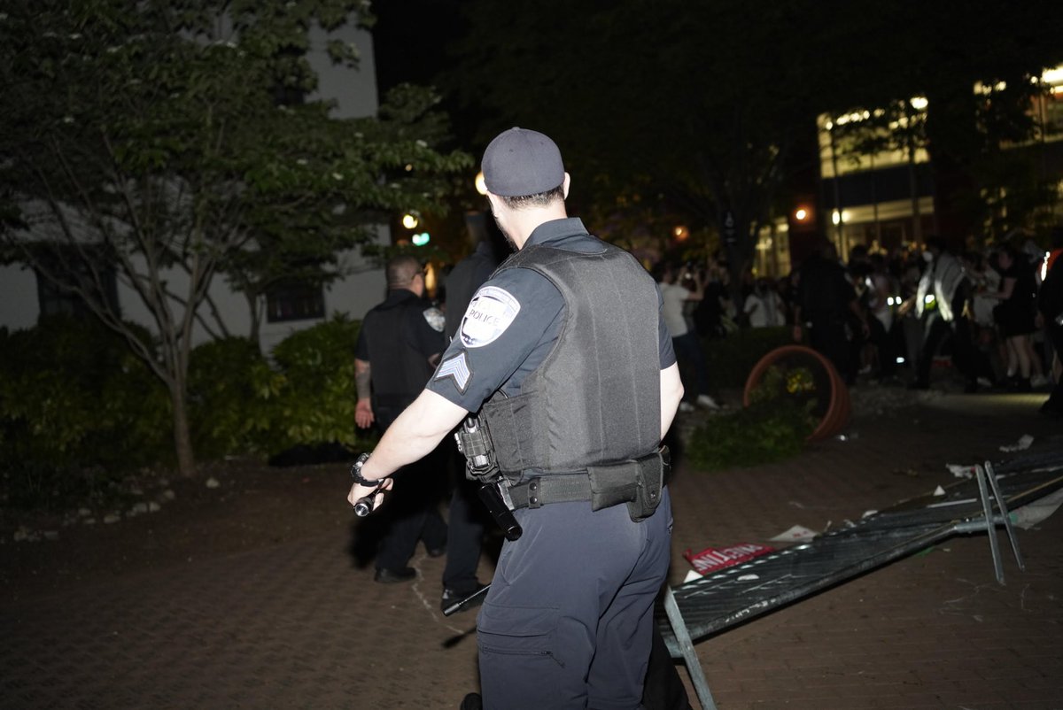 A GWPD officer took out a baton while walking toward student protesters in U-Yard after demonstrators broke down GW’s barricades