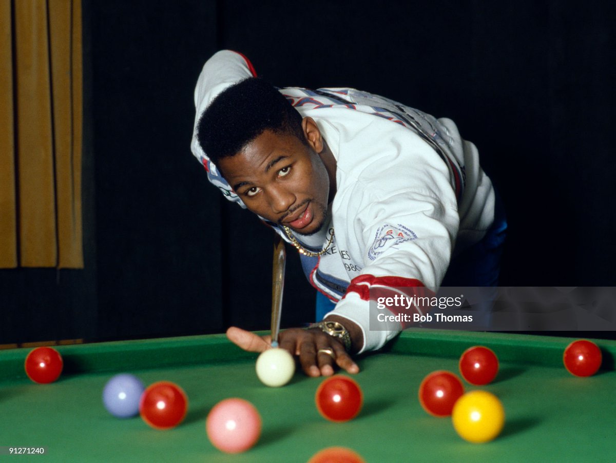 British heavyweight boxer Lennox Lewis relaxing with a game of snooker, in London (1989)