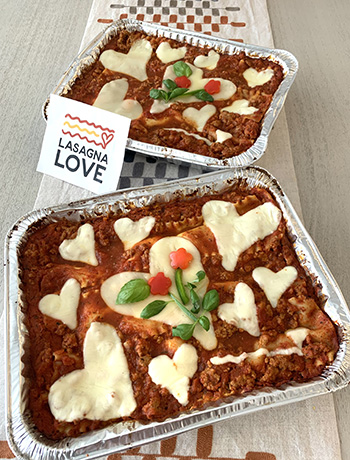 Pictured: Lasagnas topped with heart-shaped cheese prepared by volunteers of MIT alum-founded @WeRLasagnaLove. bit.ly/3Uw29F9