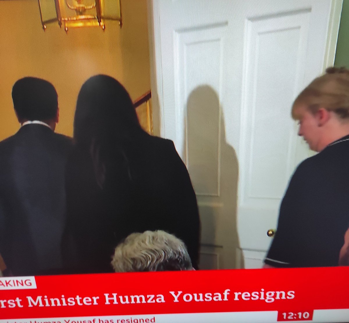 Humza Yousless walks away in tears with his wife, followed by Shona Robison, who probably thinks that she's in Asda.